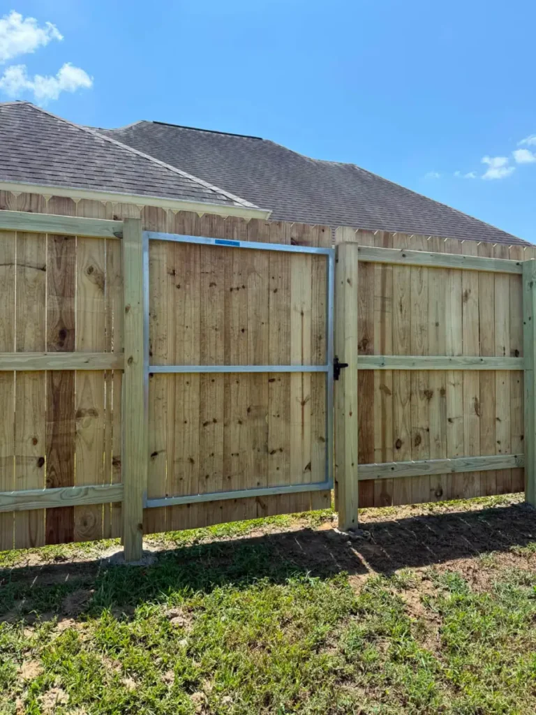 A new wood fence gate built on a welded steel frame for a Denham Springs back yard.